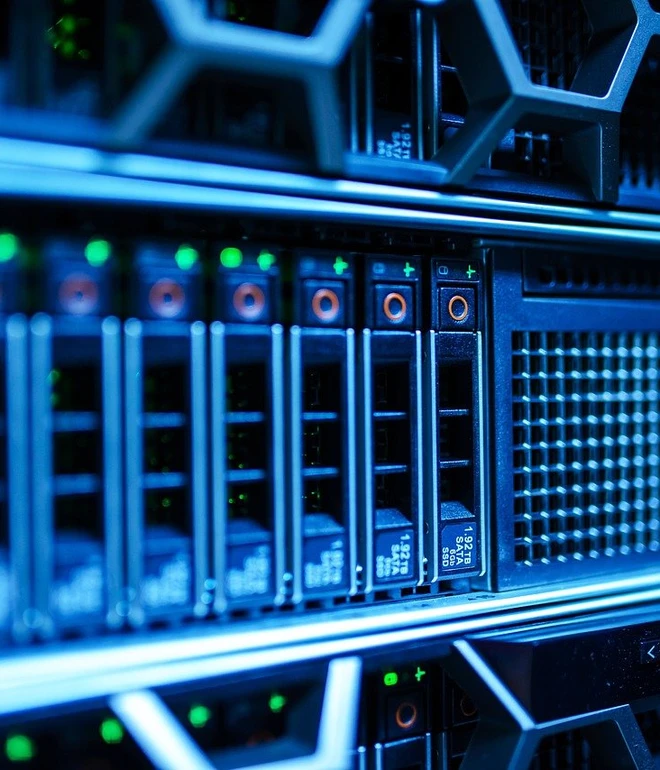 Close-up of a blue-lit server rack with multiple drive bays and front-panel indicators.