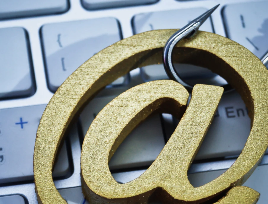 Close-up of a gold '@' symbol on a computer keyboard.